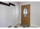 Inviting entryway with an oak front door with decorative glass and coat rack at 6280 Quay St, Arvada, CO 80003