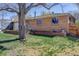 Quaint brick home with green lawn and mature shade tree in a quiet residential neighborhood at 6280 Quay St, Arvada, CO 80003