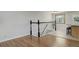 A hallway featuring hardwood flooring, a staircase, and a window for natural light at 6280 Quay St, Arvada, CO 80003