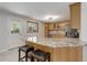 Bright, updated kitchen with granite countertops, stainless appliances, and a view of the backyard at 6280 Quay St, Arvada, CO 80003