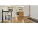 Open-concept living room featuring beautiful wood floors, new staircase and bar seating at 6280 Quay St, Arvada, CO 80003