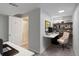 Well-lit home office featuring built-in shelves, desk, and an adjacent bathroom with a shower at 6280 Quay St, Arvada, CO 80003