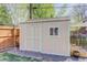 Well-maintained storage shed with a window and double doors, adjacent to a wooden fence at 6280 Quay St, Arvada, CO 80003