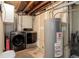 Utility room features a large capacity washer and dryer and a Rheem water heater at 6280 Quay St, Arvada, CO 80003