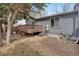 Backyard featuring a wooden deck, gravel landscaping, and home's gray exterior at 1972 S Carr St, Lakewood, CO 80227