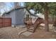 Backyard featuring a wooden deck, gravel landscaping, and home's gray exterior at 1972 S Carr St, Lakewood, CO 80227