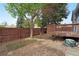 Backyard featuring a deck, fenced-in yard with natural surroundings, gravel, and landscaping at 1972 S Carr St, Lakewood, CO 80227