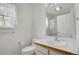 Bright bathroom featuring a single sink vanity, mirror, and shower over tub at 1972 S Carr St, Lakewood, CO 80227