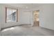 Bright bedroom with plush carpeting and an open doorway leading to adjacent living areas at 1972 S Carr St, Lakewood, CO 80227