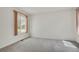 Bedroom featuring neutral carpeting, window, and ample closet space at 1972 S Carr St, Lakewood, CO 80227