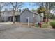Gray home with drought-resistant landscaping, view of adjoining home and neighborhood street at 1972 S Carr St, Lakewood, CO 80227