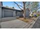 Gray home featuring a garage, walkway, and drought-resistant landscaping in a well-maintained community at 1972 S Carr St, Lakewood, CO 80227