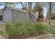 Gray home with mature landscaping, a view of the backyard fence, and street at 1972 S Carr St, Lakewood, CO 80227
