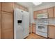 Bright kitchen featuring white appliances, light wood cabinets, and a light, airy feeling at 1972 S Carr St, Lakewood, CO 80227