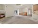 Open-concept living room with a fireplace, window, and stairs leading to the upper level at 1972 S Carr St, Lakewood, CO 80227