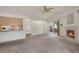 Open living room with vaulted ceilings, a fireplace, sliding glass doors, and an opening to the kitchen at 1972 S Carr St, Lakewood, CO 80227
