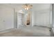 Bright main bedroom featuring multiple closets, a ceiling fan, and an ensuite bathroom at 1972 S Carr St, Lakewood, CO 80227