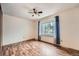 Neutral bedroom with wood floors, ceiling fan, and natural light at 18981 E Mercer Dr, Aurora, CO 80013