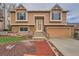 Charming two-story home featuring a well-maintained front yard and inviting entryway at 18981 E Mercer Dr, Aurora, CO 80013