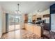 Bright kitchen with wood cabinets, granite countertops, stainless steel appliances, and access to deck at 18981 E Mercer Dr, Aurora, CO 80013