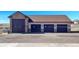 A detached garage with multiple bays and exterior lighting at 620 Coyote Trl, Elizabeth, CO 80107