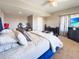 Main bedroom with king bed, soft carpet, desk with gaming computer, and ensuite bathroom at 620 Coyote Trl, Elizabeth, CO 80107