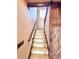 Staircase with decorative sliding wooden door and natural light at 620 Coyote Trl, Elizabeth, CO 80107