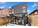 This modern home has a sleek black exterior with an outdoor area at 3709 Tejon St, Denver, CO 80211