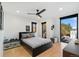 This cozy bedroom is complete with a ceiling fan, mounted TV, and lots of natural light at 3709 Tejon St, Denver, CO 80211