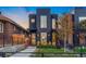 Striking black home with a modern design, large windows, and well-maintained front yard at 3709 Tejon St, Denver, CO 80211