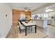 Dining area with wood accent wall, dining table and chairs, with view into kitchen at 9501 W 89Th Cir, Broomfield, CO 80021