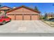Spacious four-car garage with large driveway on a sunny day, providing ample parking and storage at 9501 W 89Th Cir, Broomfield, CO 80021