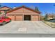 Spacious four-car garage with one bay open, providing ample parking and storage at 9501 W 89Th Cir, Broomfield, CO 80021