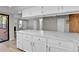 Bright, open-concept kitchen features white cabinets, marble counters, and views of living spaces at 9501 W 89Th Cir, Broomfield, CO 80021