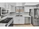 Well-lit kitchen features marble countertops, stainless appliances, and modern white cabinetry at 9501 W 89Th Cir, Broomfield, CO 80021