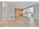 An open floor plan features a bright kitchen and dining area with wood accent wall at 9501 W 89Th Cir, Broomfield, CO 80021