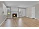 Bright living room featuring a stone fireplace, ample natural light, and hardwood floors at 9501 W 89Th Cir, Broomfield, CO 80021