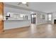 Open-concept living space with kitchen featuring stainless steel appliances and wood accent wall at 9501 W 89Th Cir, Broomfield, CO 80021