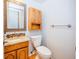 This bathroom features a decorative mirror and granite countertops with wooden cabinets at 2523 E Geddes Ave, Centennial, CO 80122