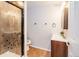 Tiled bathroom features shower with glass door, vanity and updated fixtures at 2523 E Geddes Ave, Centennial, CO 80122