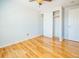 Bright bedroom features hardwood floors, ceiling fan and closet with sliding doors at 2523 E Geddes Ave, Centennial, CO 80122