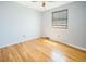This empty bedroom features hardwood floors, neutral walls and a window at 2523 E Geddes Ave, Centennial, CO 80122