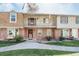 Inviting brick townhome with a charming balcony, complemented by a well-kept lawn and walkway at 2523 E Geddes Ave, Centennial, CO 80122