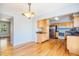 Bright dining area adjacent to a modern kitchen featuring stainless steel appliances and hardwood floors at 2523 E Geddes Ave, Centennial, CO 80122