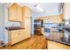 Well-lit kitchen features wooden cabinets, stainless steel appliances, and hardwood floors for a modern touch at 2523 E Geddes Ave, Centennial, CO 80122