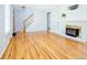 Inviting living area with hardwood floors, classic fireplace, and staircase to upper level at 2523 E Geddes Ave, Centennial, CO 80122