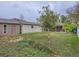 Backyard featuring lush grass, a white fence, a detached garage, and a covered patio at 5481 Xanadu St, Denver, CO 80239