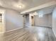 Finished basement with wood-look floors, neutral paint, and a closet with mirrored doors at 5481 Xanadu St, Denver, CO 80239