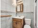 Bathroom featuring tile floors, vanity, and tile walls at 5481 Xanadu St, Denver, CO 80239