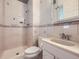Bathroom featuring tiled walls, a vanity, and a walk-in shower at 5481 Xanadu St, Denver, CO 80239
